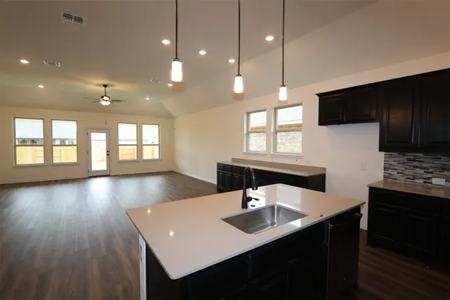 a view of kitchen with cabinets and wooden floor