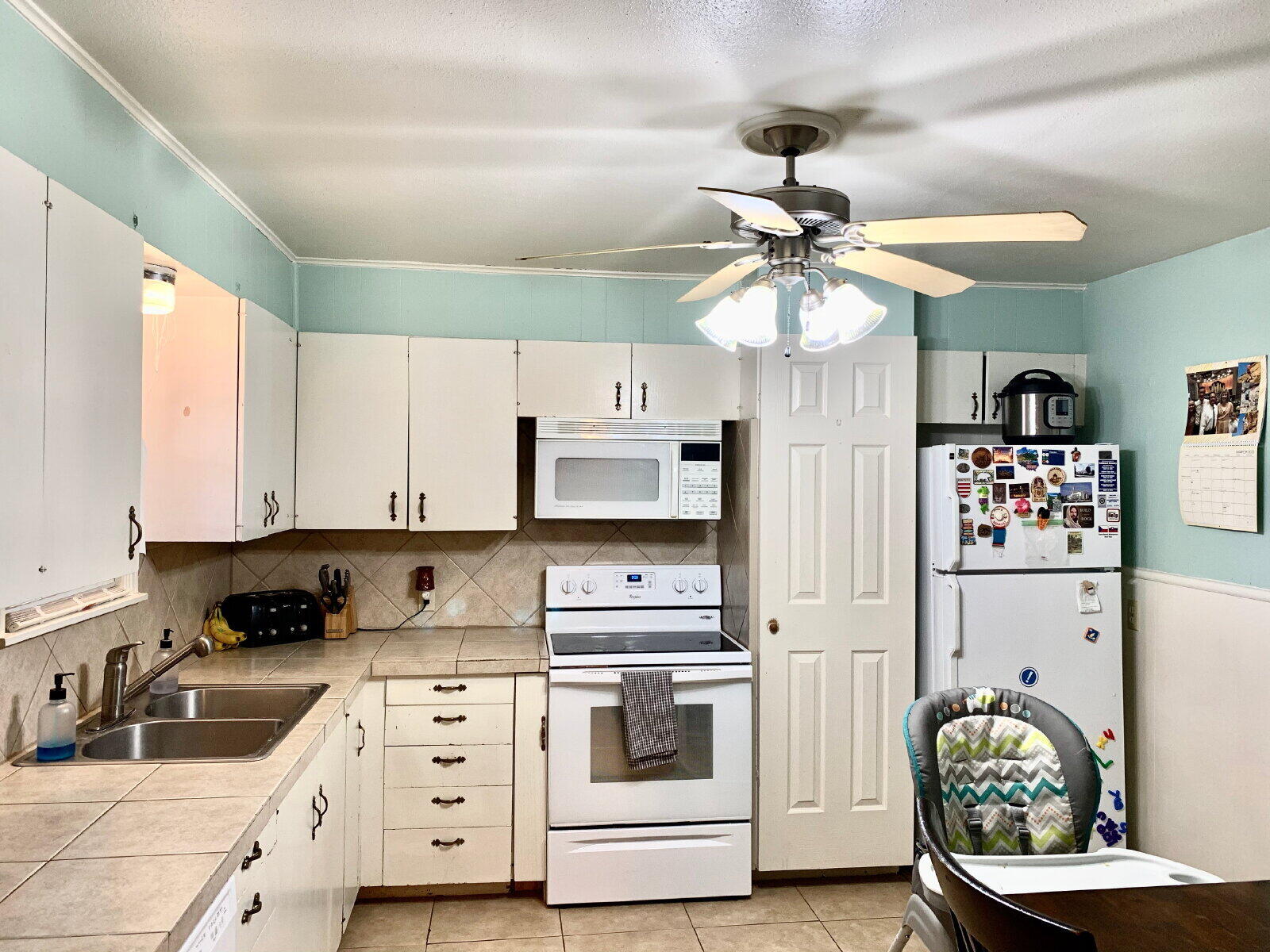 4206 45th Street Lubbock, TX 79413 - Photo 4 of 14 a kitchen with stainless steel appliances a white cabinets and stove top oven