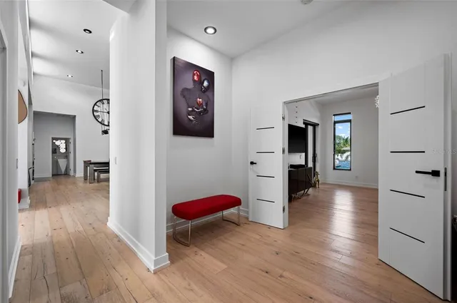a spacious bedroom with a bed and a chandelier