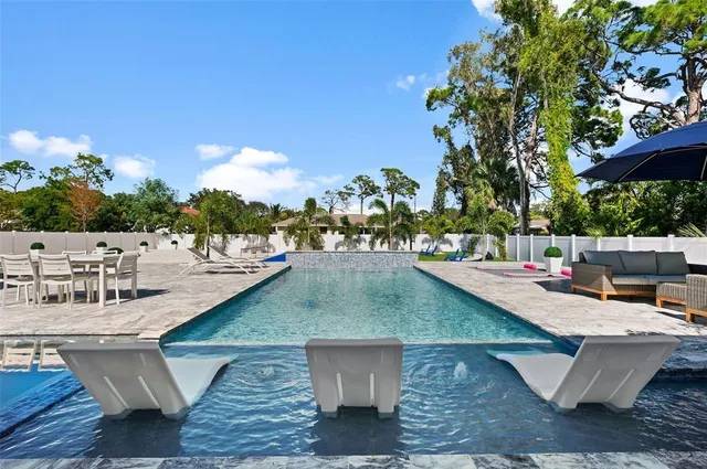 a view of swimming pool with outdoor seating