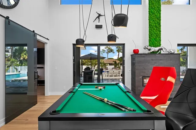 a room with stainless steel appliances kitchen island granite countertop furniture and a view of living room