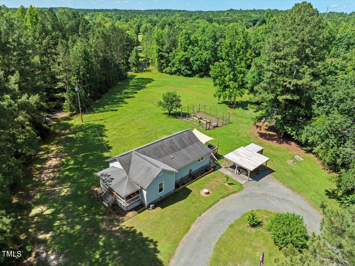 an aerial view of a house with a yard