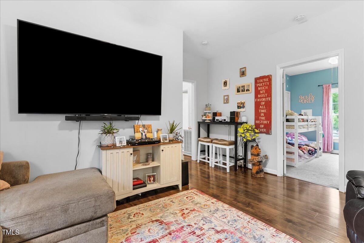 3151 Brogden Road Stem, NC 27581 - Photo 14 of 58 a living room with furniture and a flat screen tv