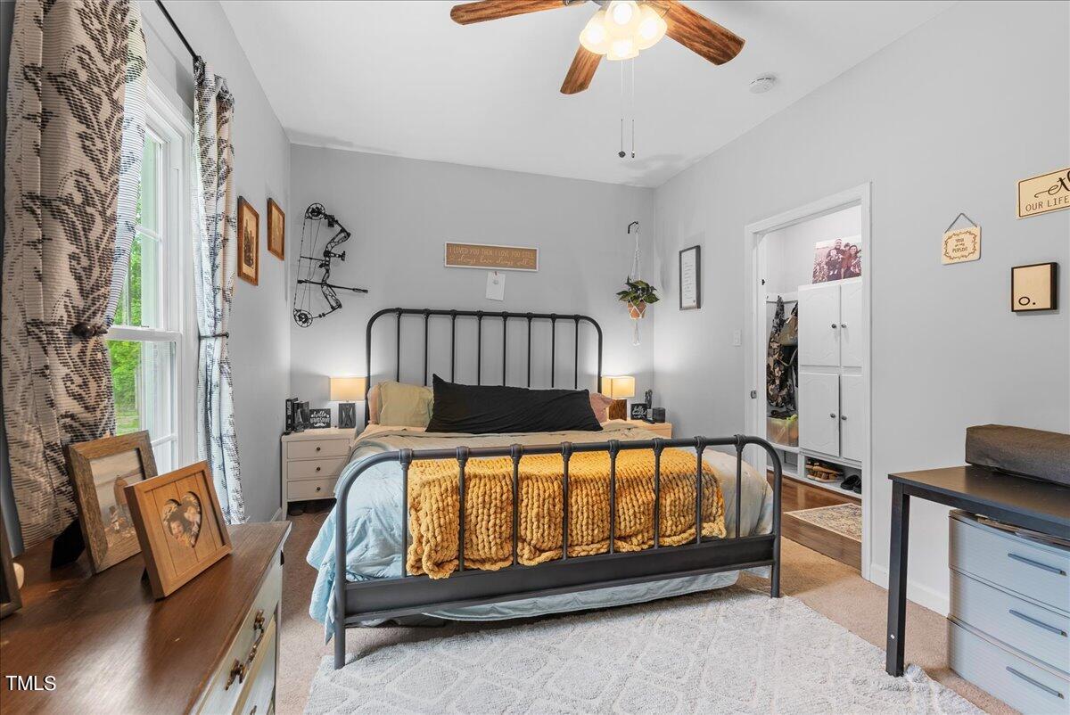 3151 Brogden Road Stem, NC 27581 - Photo 17 of 58 a bed sitting in a bedroom next to a window