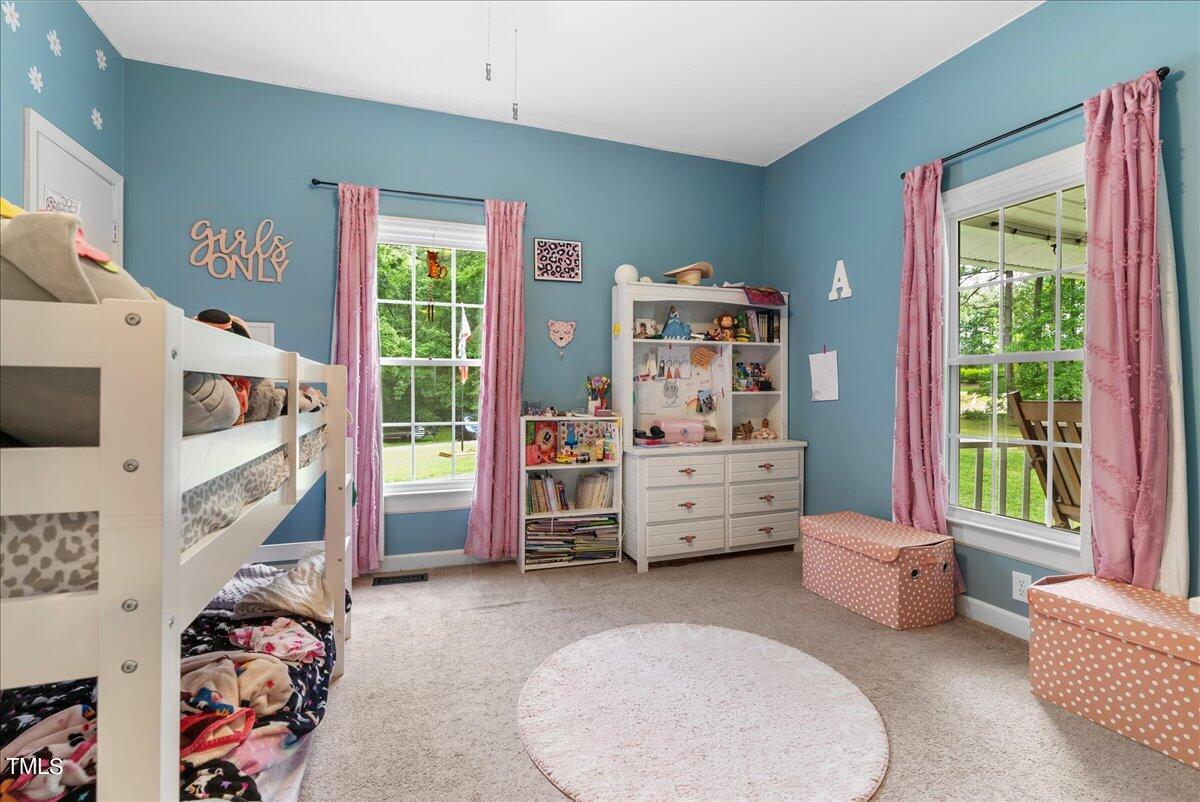 3151 Brogden Road Stem, NC 27581 - Photo 19 of 58 a bedroom with furniture and a large window