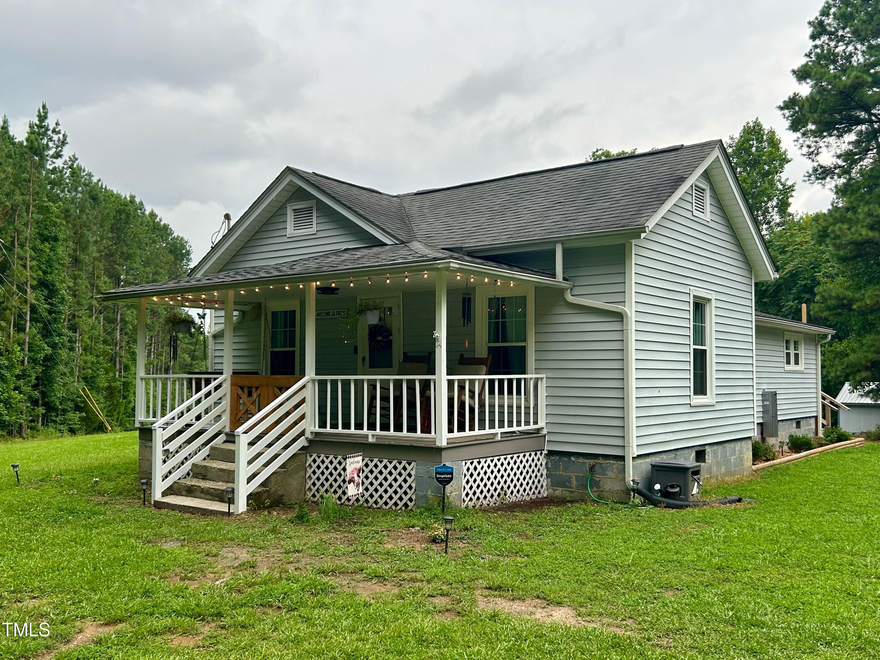 3151 Brogden Road Stem, NC 27581 - Photo 2 of 58 a front view of a house with a garden