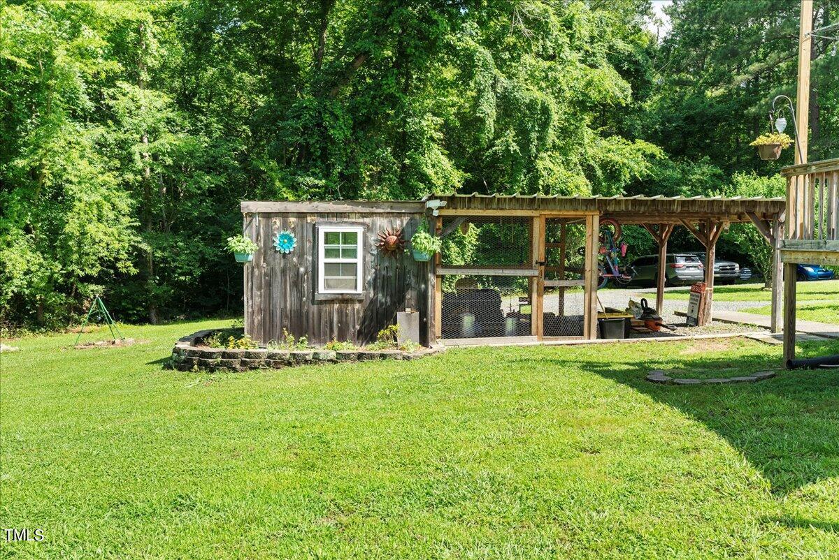 3151 Brogden Road Stem, NC 27581 - Photo 28 of 58 a white house that has garden in front of it