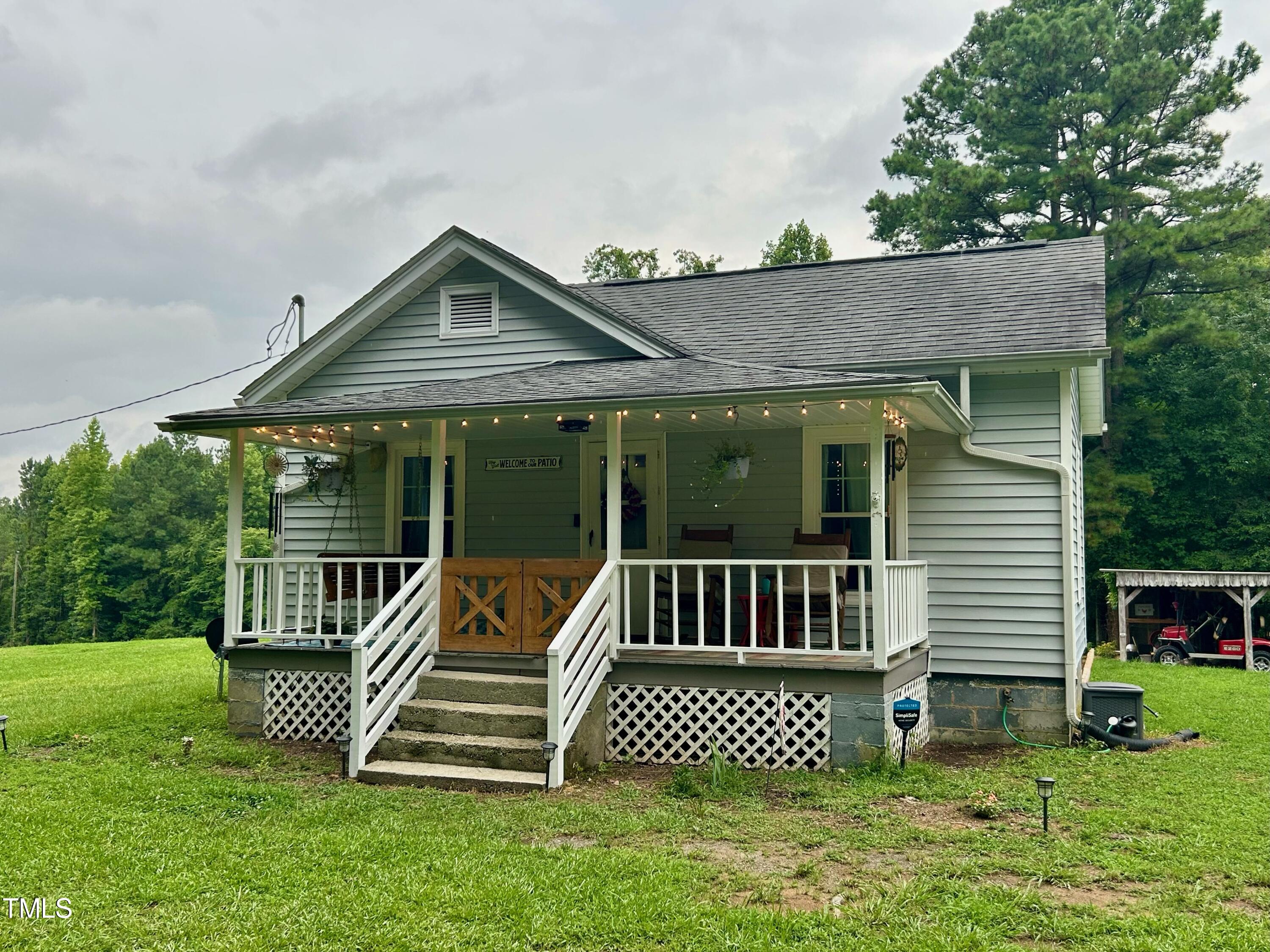 3151 Brogden Road Stem, NC 27581 - Photo 3 of 58 a front view of a house with garden