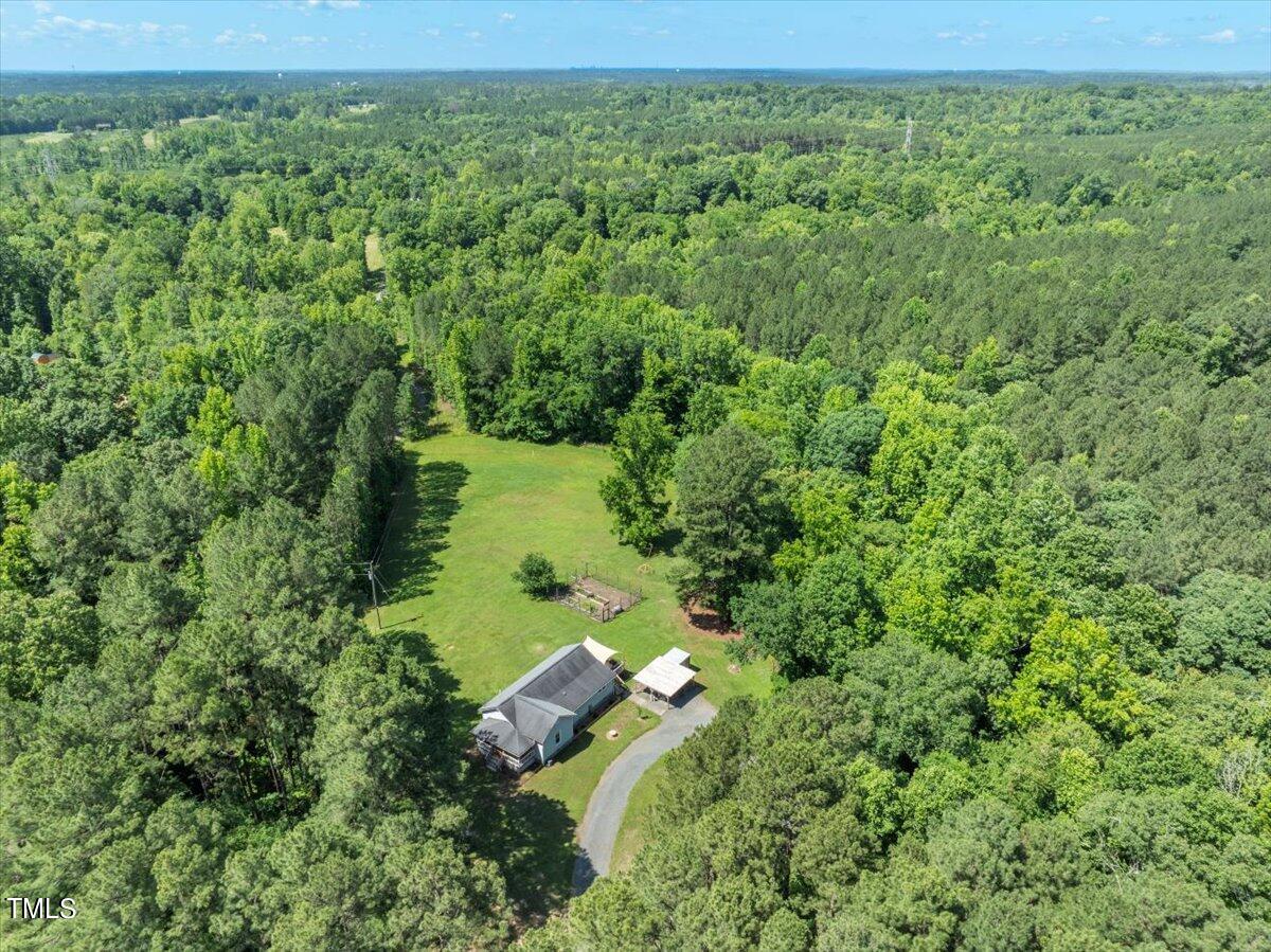 3151 Brogden Road Stem, NC 27581 - Photo 33 of 58 a view of a garden with a lake