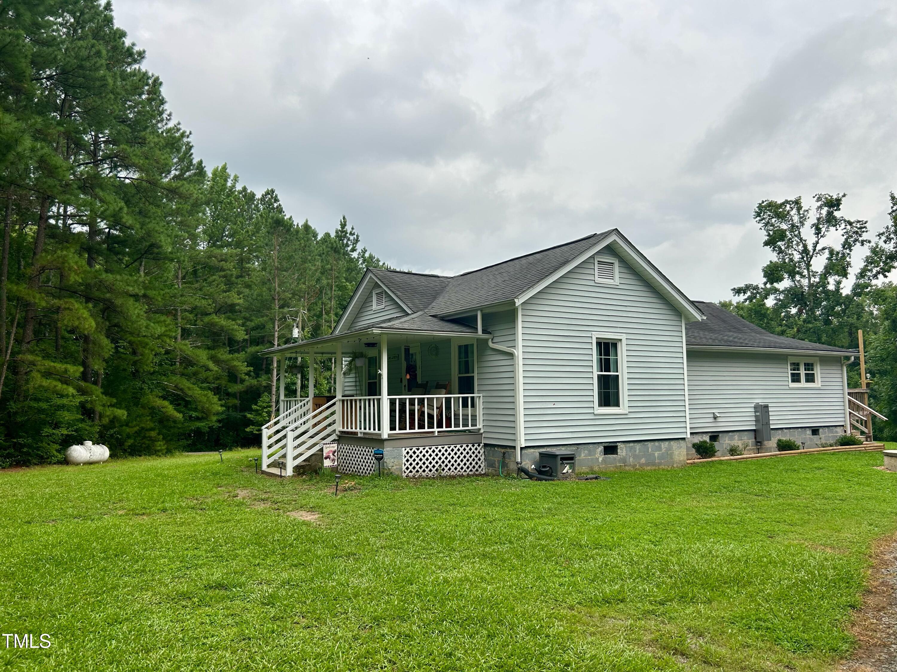 3151 Brogden Road Stem, NC 27581 - Photo 4 of 58 a front view of house with a garden