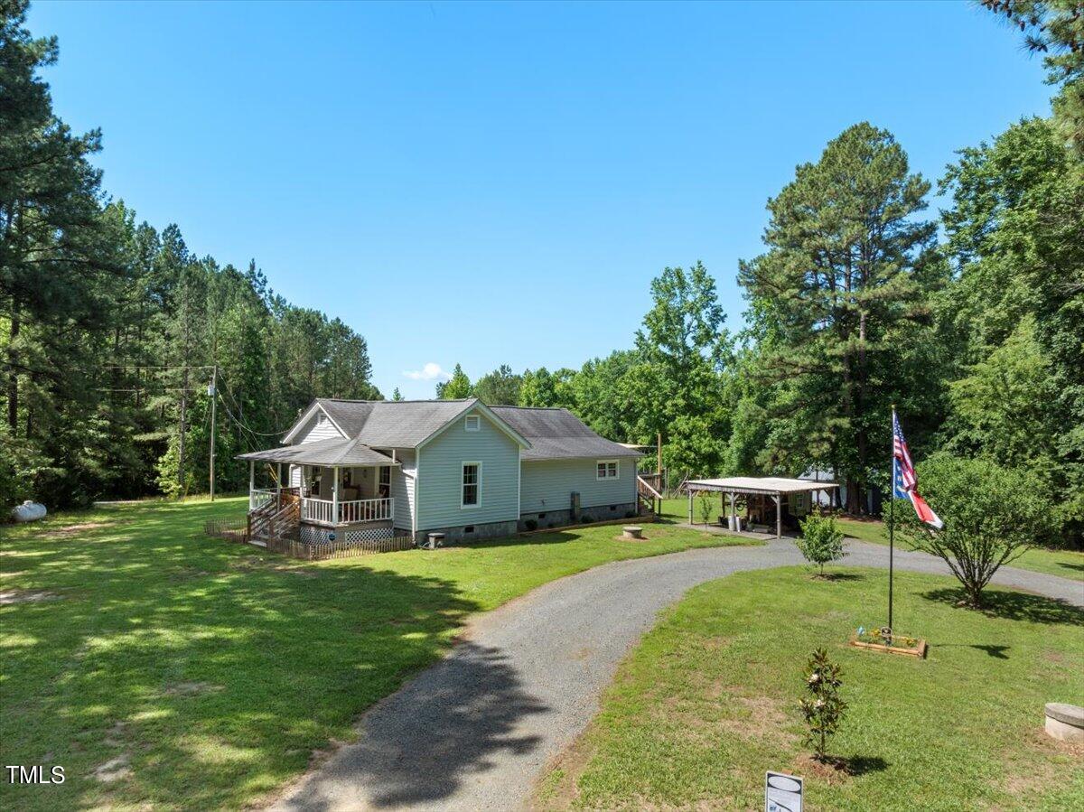 3151 Brogden Road Stem, NC 27581 - Photo 41 of 58 a view of house with garden and trees