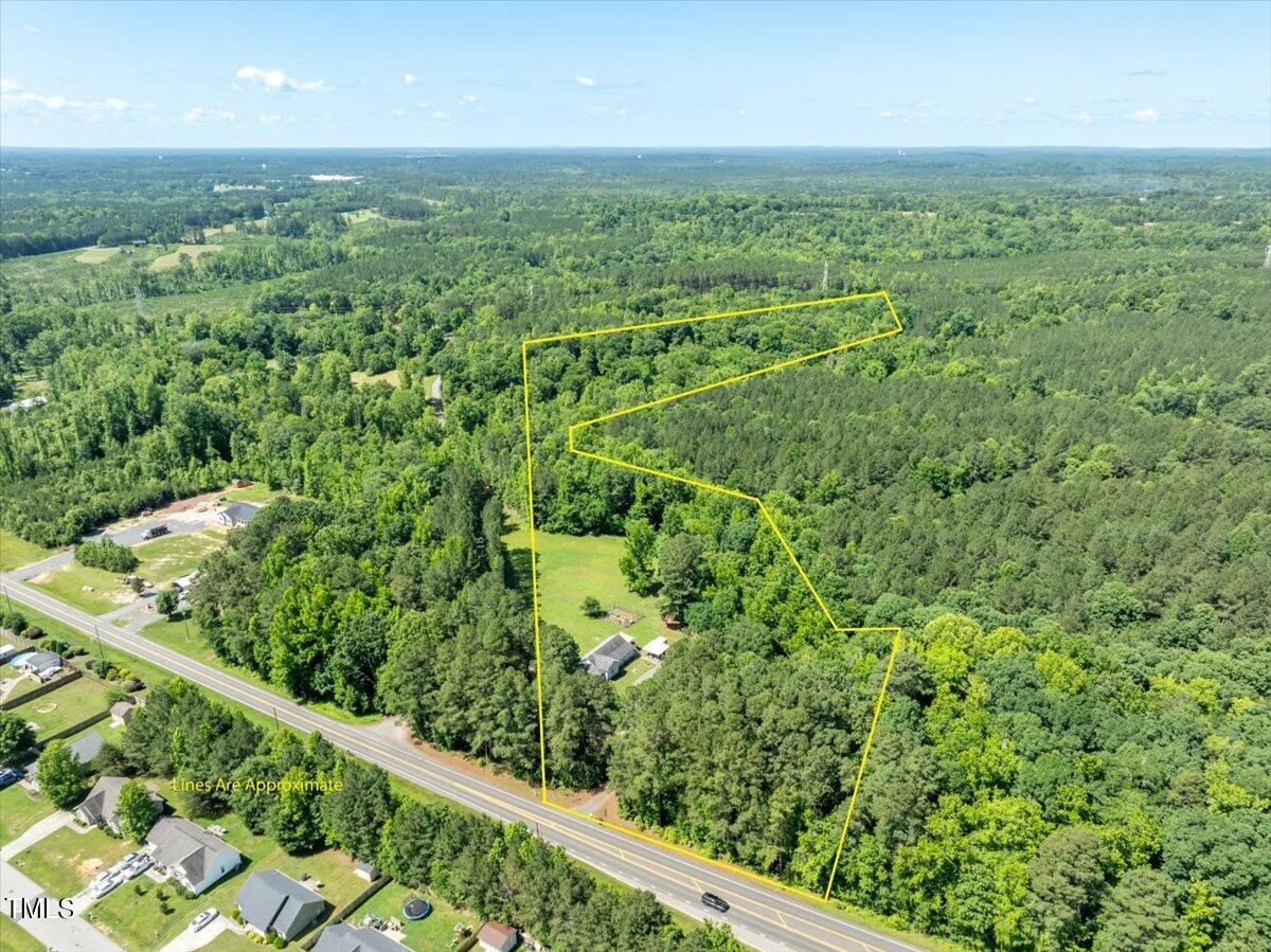3151 Brogden Road Stem, NC 27581 - Photo 5 of 58 a view of a green field with lots of bushes