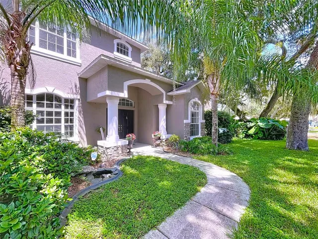 a kitchen with stainless steel appliances granite countertop a stove top oven a sink dishwasher a dining table and chairs with wooden floor