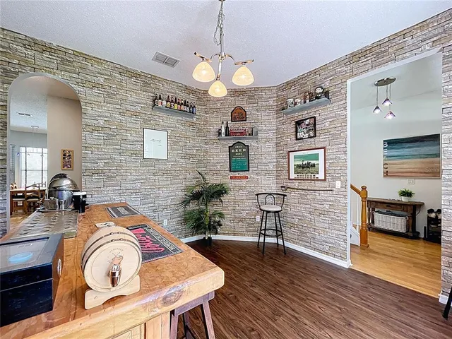 a kitchen with stainless steel appliances granite countertop a sink and cabinets with wooden floor