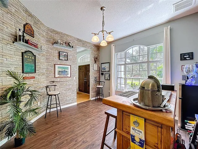 a view of a hallway with wooden floor and stairs