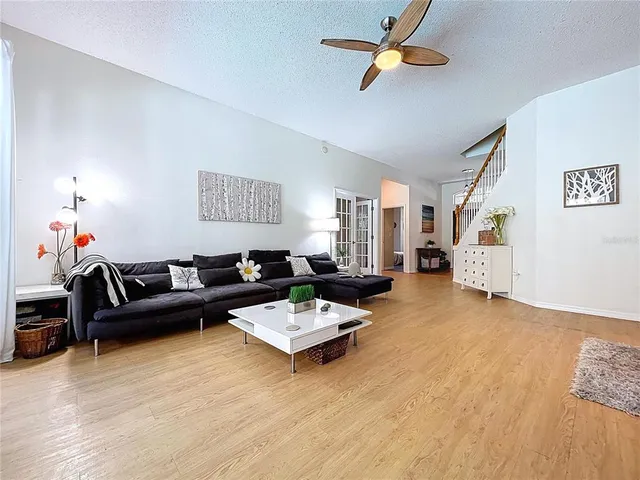 a view of a hallway with wooden floor and staircase