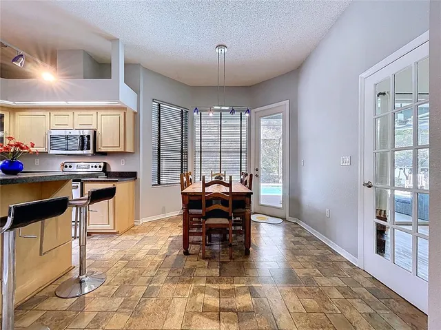 a bathroom with a granite countertop sink a mirror and a window