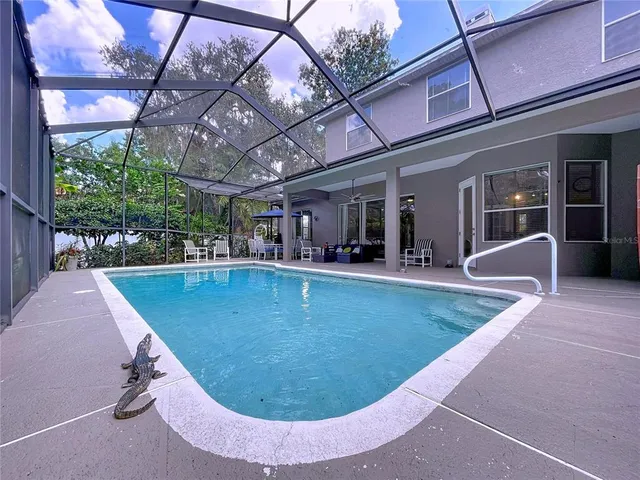 a view of a swimming pool with a yard