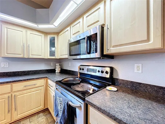 a bathroom with a granite countertop sink and a large mirror