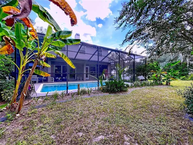 an aerial view of a house with a yard and garden