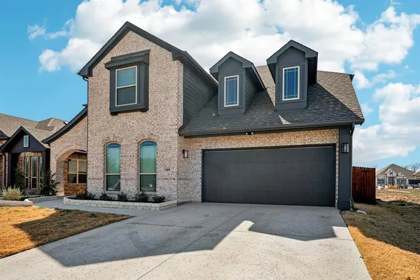 a front view of a house with yard