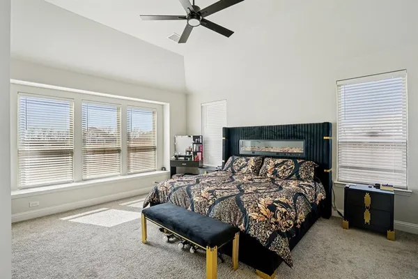 a bedroom with a bed and a large window