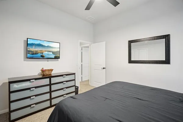 a bedroom with a bed and a painting on the wall