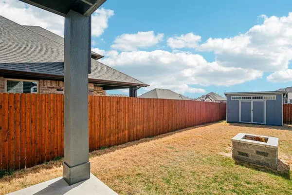a view of backyard with cabin