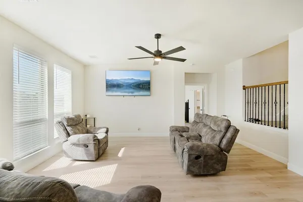 a bedroom with furniture and a large window