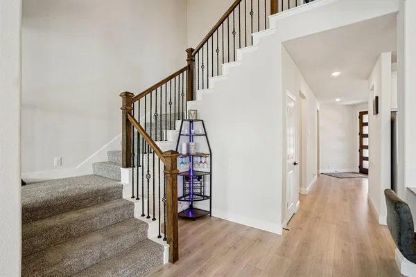 a view of entryway with wooden floor and stairs