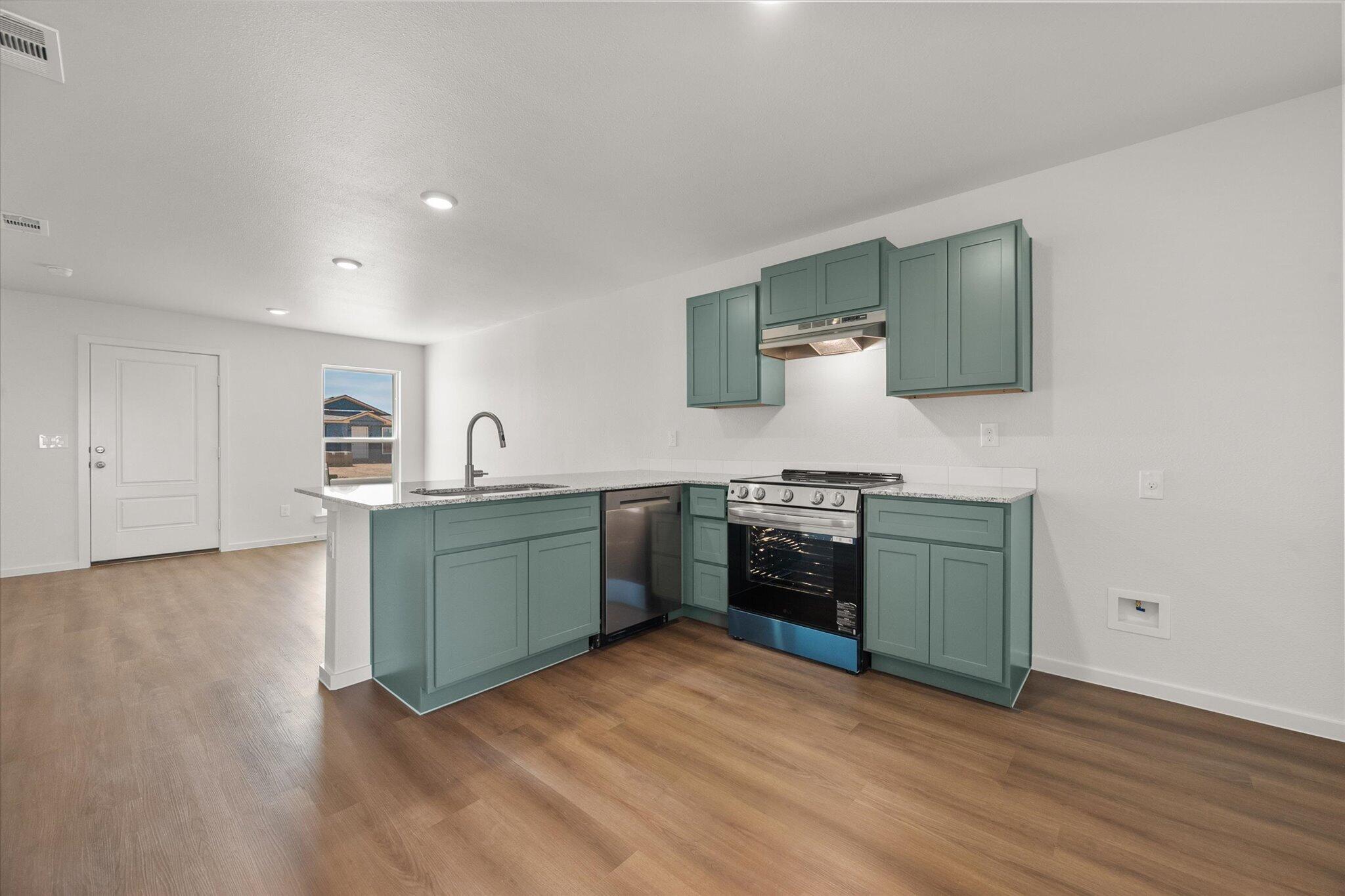 5518 Smith Street Lubbock, TX 79416 - Photo 14 of 22 a kitchen with a sink and a stove top oven