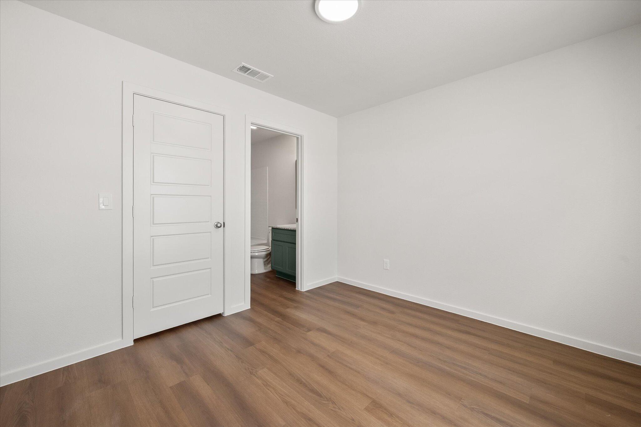 5518 Smith Street Lubbock, TX 79416 - Photo 16 of 22 an empty room with wooden floor