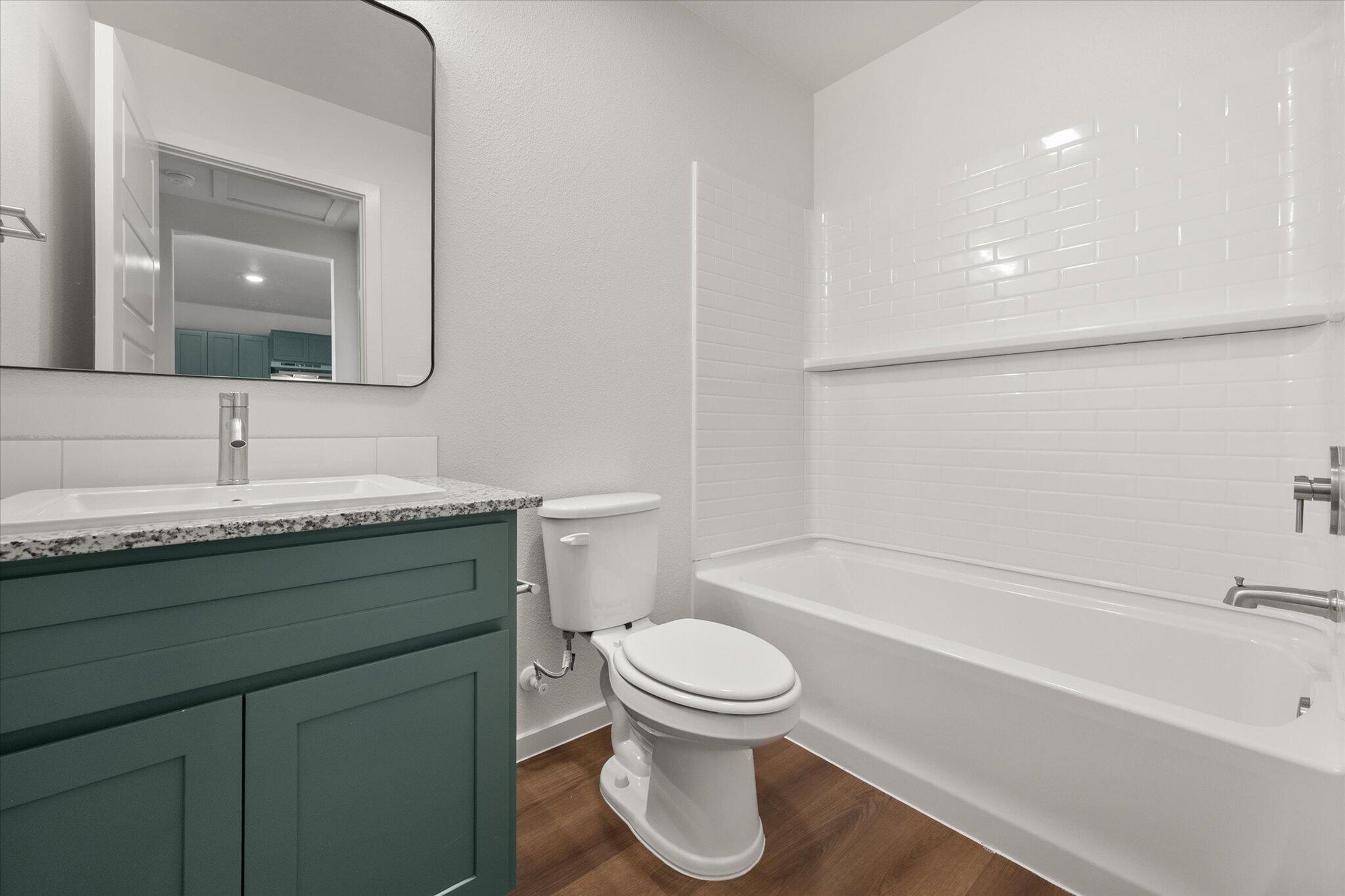 5518 Smith Street Lubbock, TX 79416 - Photo 20 of 22 a bathroom with a sink toilet and shower