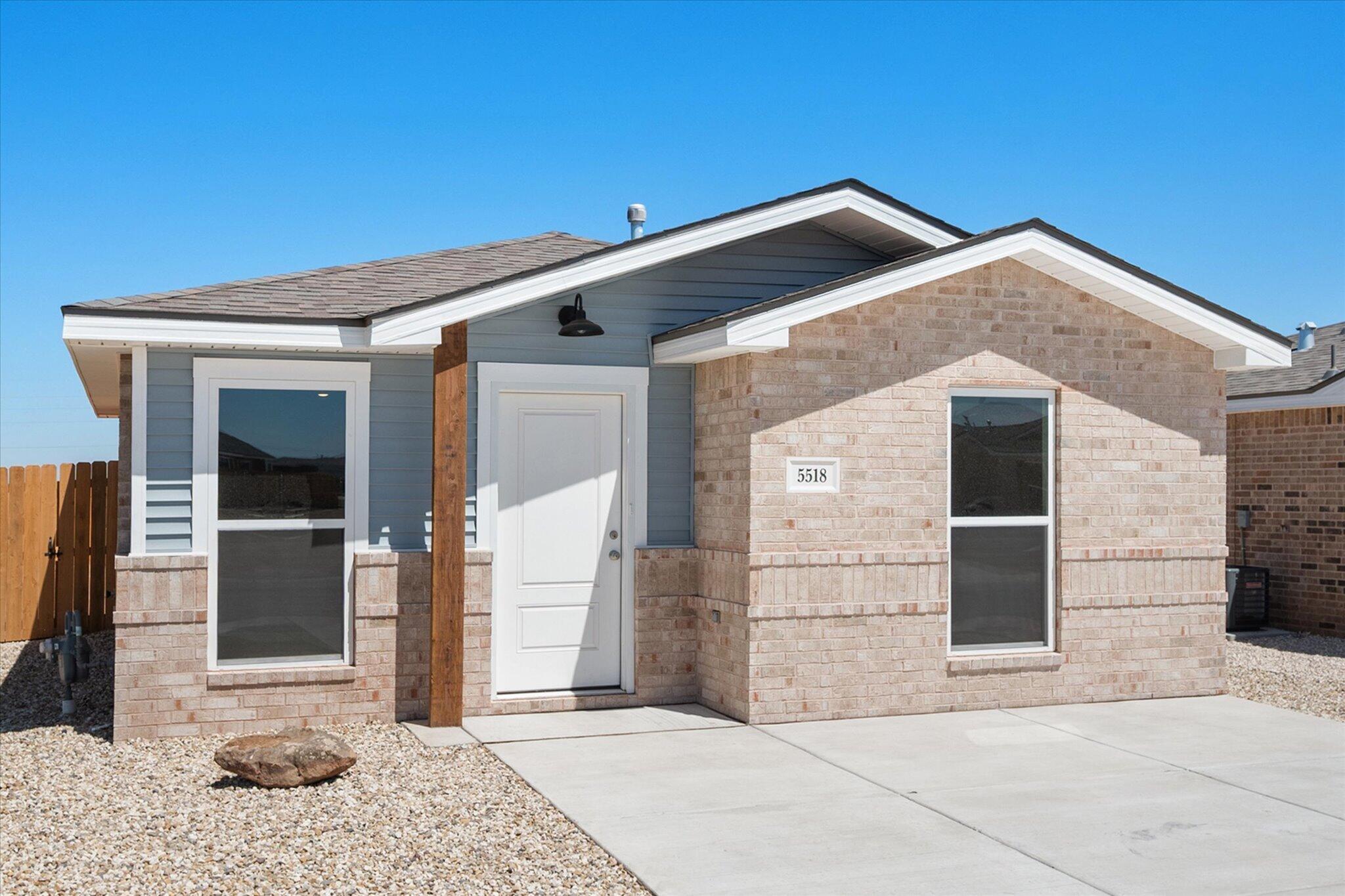 5518 Smith Street Lubbock, TX 79416 - Photo 2 of 22 a front view of a house with a yard
