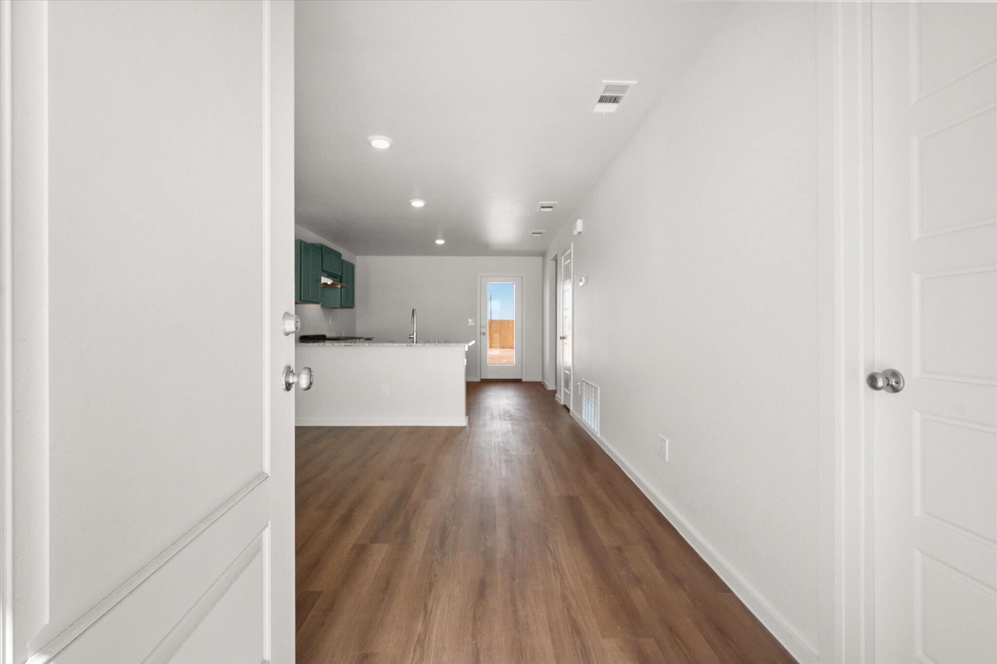 5518 Smith Street Lubbock, TX 79416 - Photo 3 of 22 a view of a hallway with wooden floor