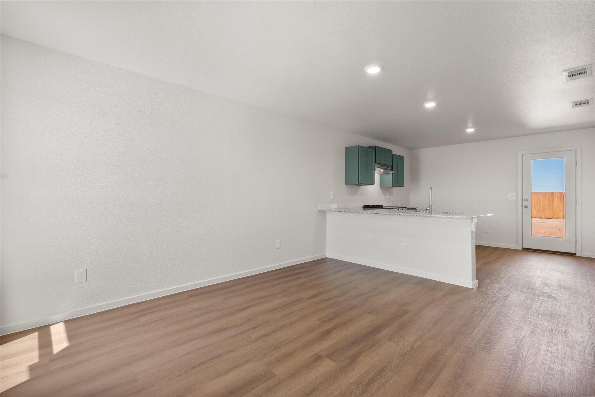 5518 Smith Street Lubbock, TX 79416 - Photo 4 of 22 a view of a kitchen with wooden floor and white wall