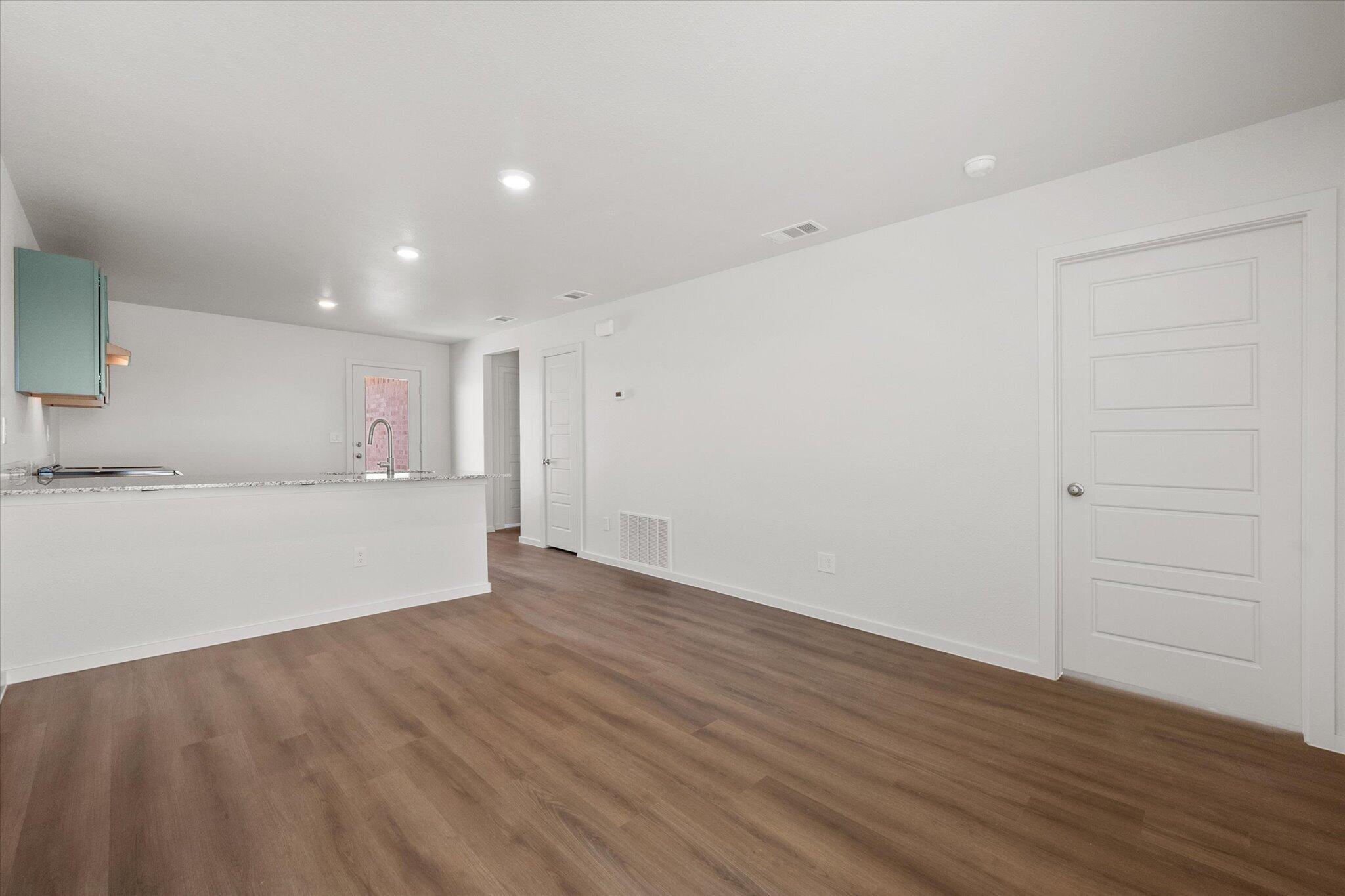 5518 Smith Street Lubbock, TX 79416 - Photo 5 of 22 an empty room with wooden floor and windows