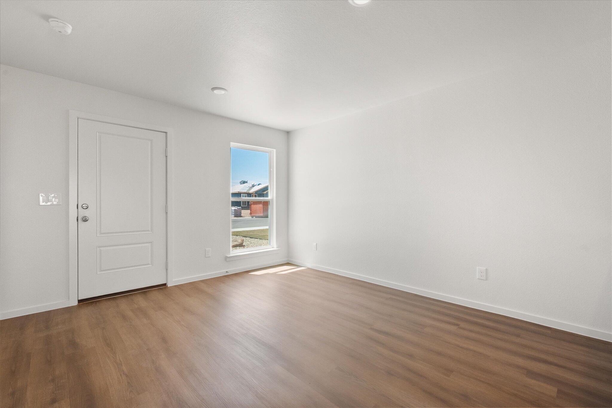 5518 Smith Street Lubbock, TX 79416 - Photo 8 of 22 a view of an empty room with wooden floor and closet
