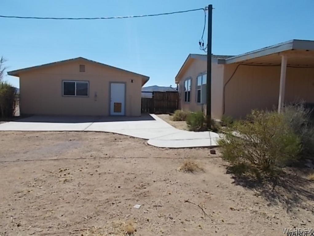 4454 Cibola Road Golden Valley, AZ 86413 - Photo 23 of 31 a front view of a house with a yard