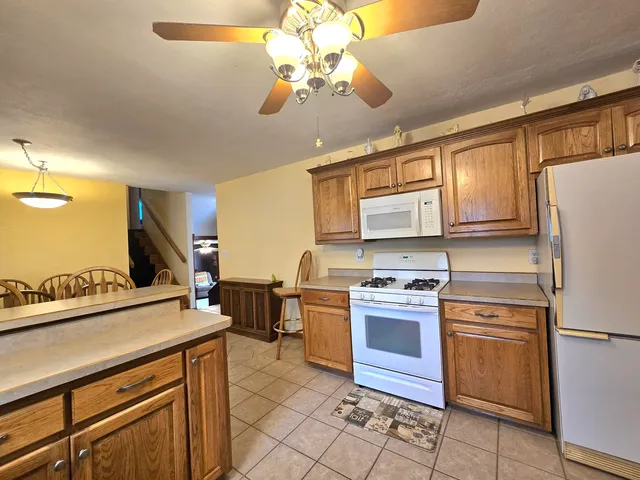 a kitchen with a stove a sink and a refrigerator