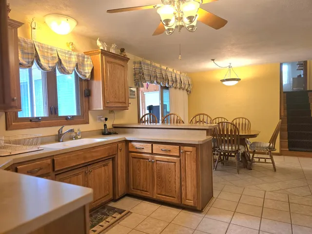 a living room with furniture potted plant and a large window