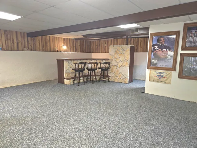 a view of a balcony with chairs and wooden floor