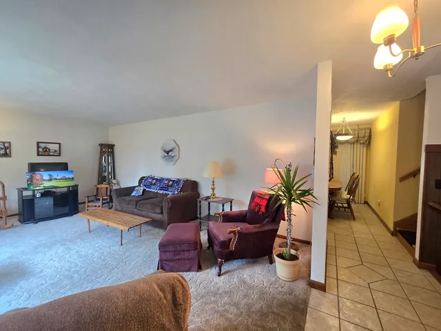 a living room with furniture and a lamp