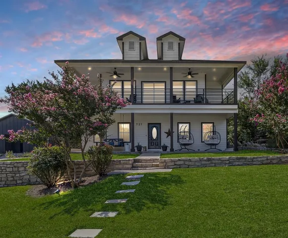 a front view of house with yard and green space