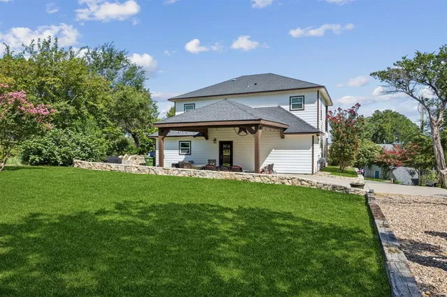 a view of a house with a yard and sitting area