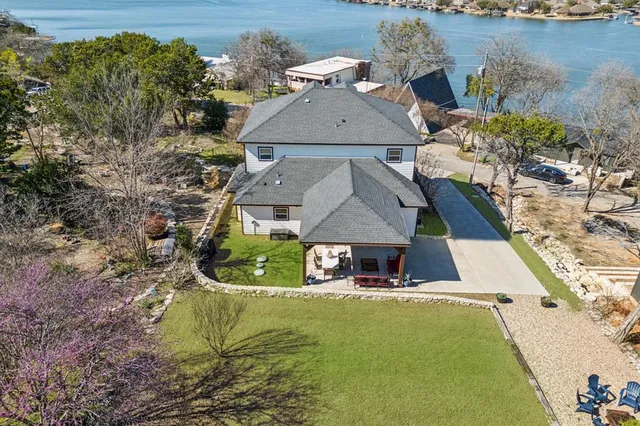 an aerial view of a house with a yard