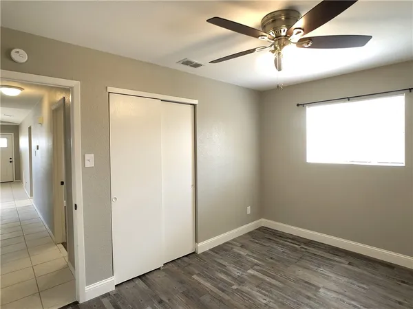 a view of an empty room and bathroom