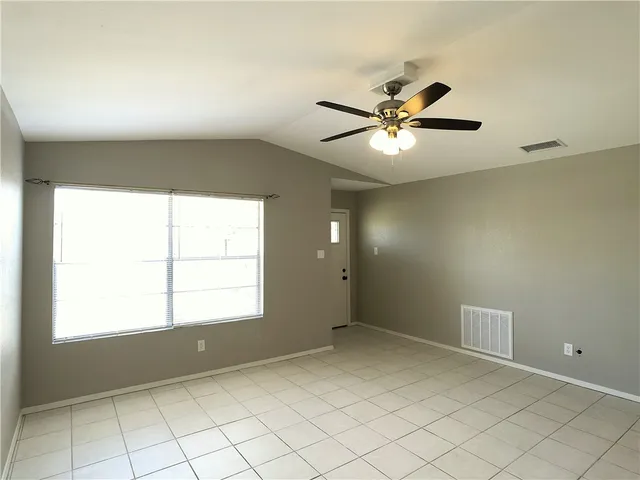 a view of an empty room with a window