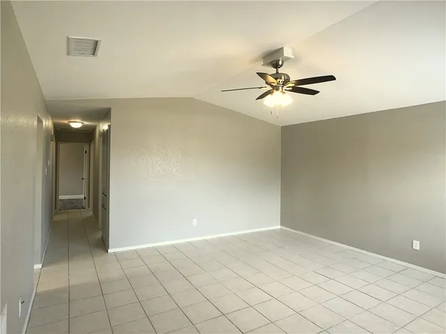 wooden floor in an empty room and a chandelier fan