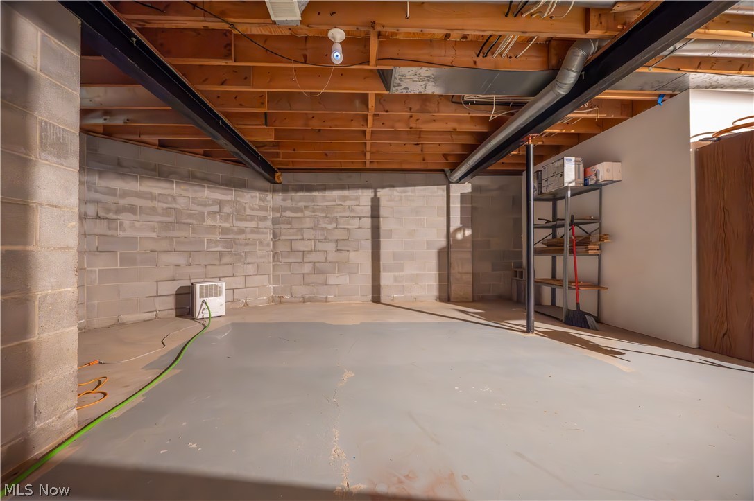 405 Airport Road Northwest Warren, OH 44481 - Photo 39 of 50 Spacious unfinished lower level featuring exposed wood joists and structural beams, and concrete block walls